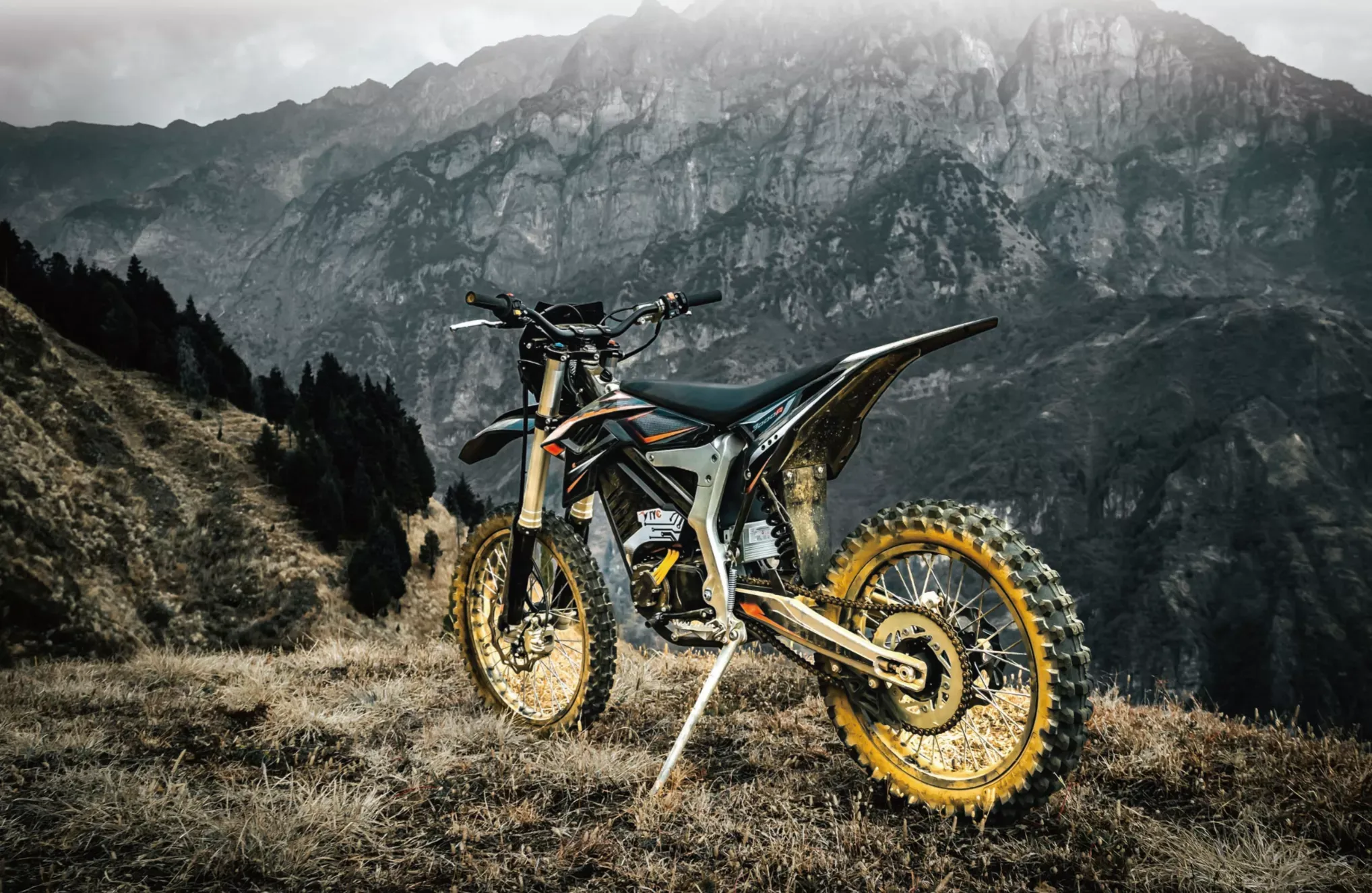 Electric off-road motorcycle overlooking mountain terrain